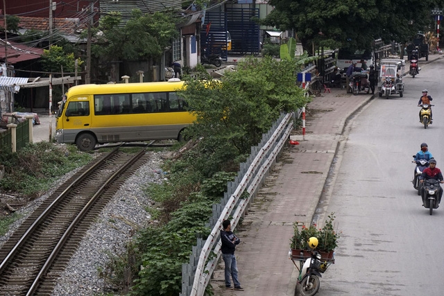 Một chiếc xe ô tô đang vượt qua đường ray để vào làng Tứ Kỳ.