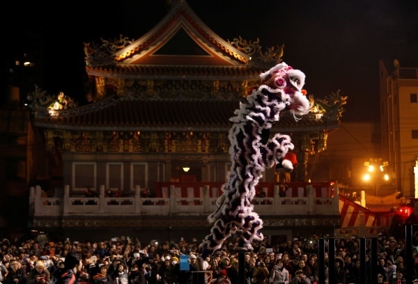 Dancers perform a lion dance in front of a temple as they celebrate the Lunar New Year in China Town, in Yokohama, south of Tokyo, Japan January 28, 2017. REUTERS/Kim Kyung-Hoon