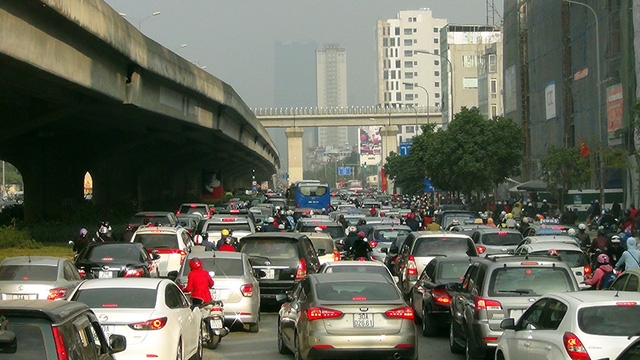  Người điều khiển xe máy luồn lách qua kẽ hở giữa các ô tô 