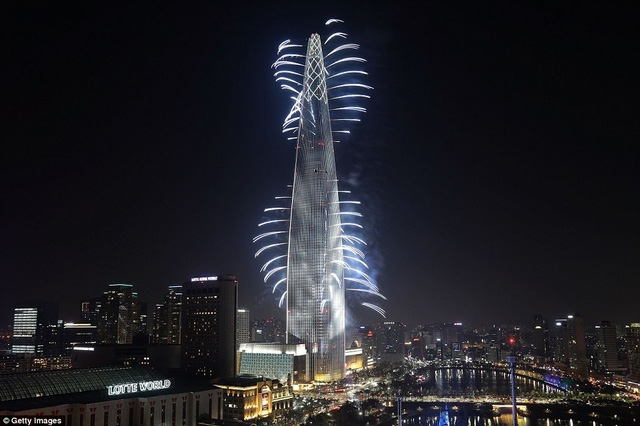 Rất đông người dân Hàn Quốc đã đổ về khu vực tòa nhà Lotte World Tower tại Seoul để theo dõi màn trình diễn đặc sắc này. (Ảnh: Getty)